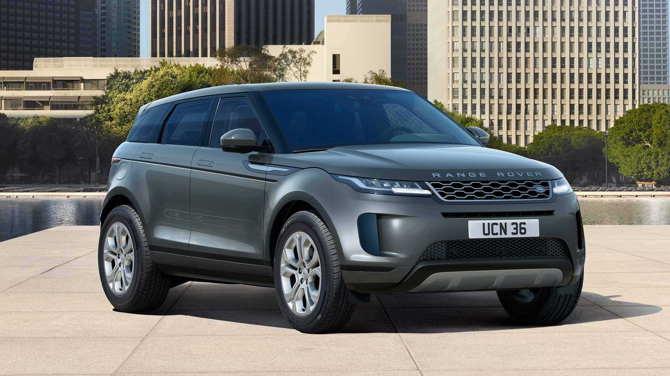 Evoque Parked By Garden Area Against Buildings In City