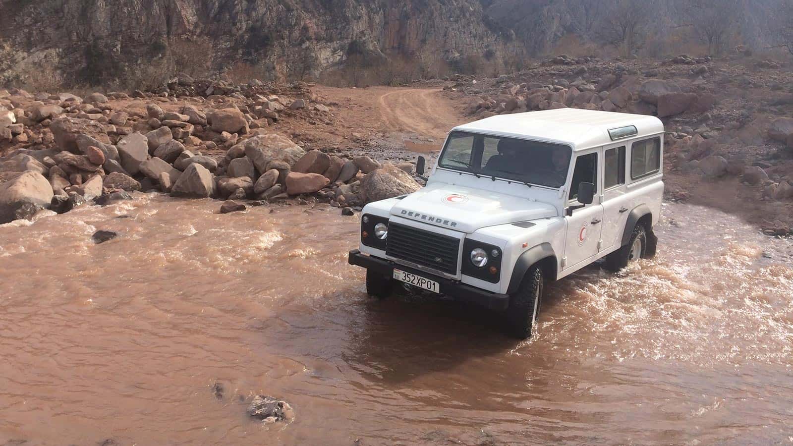 Classic Land Rover Defender driving through water